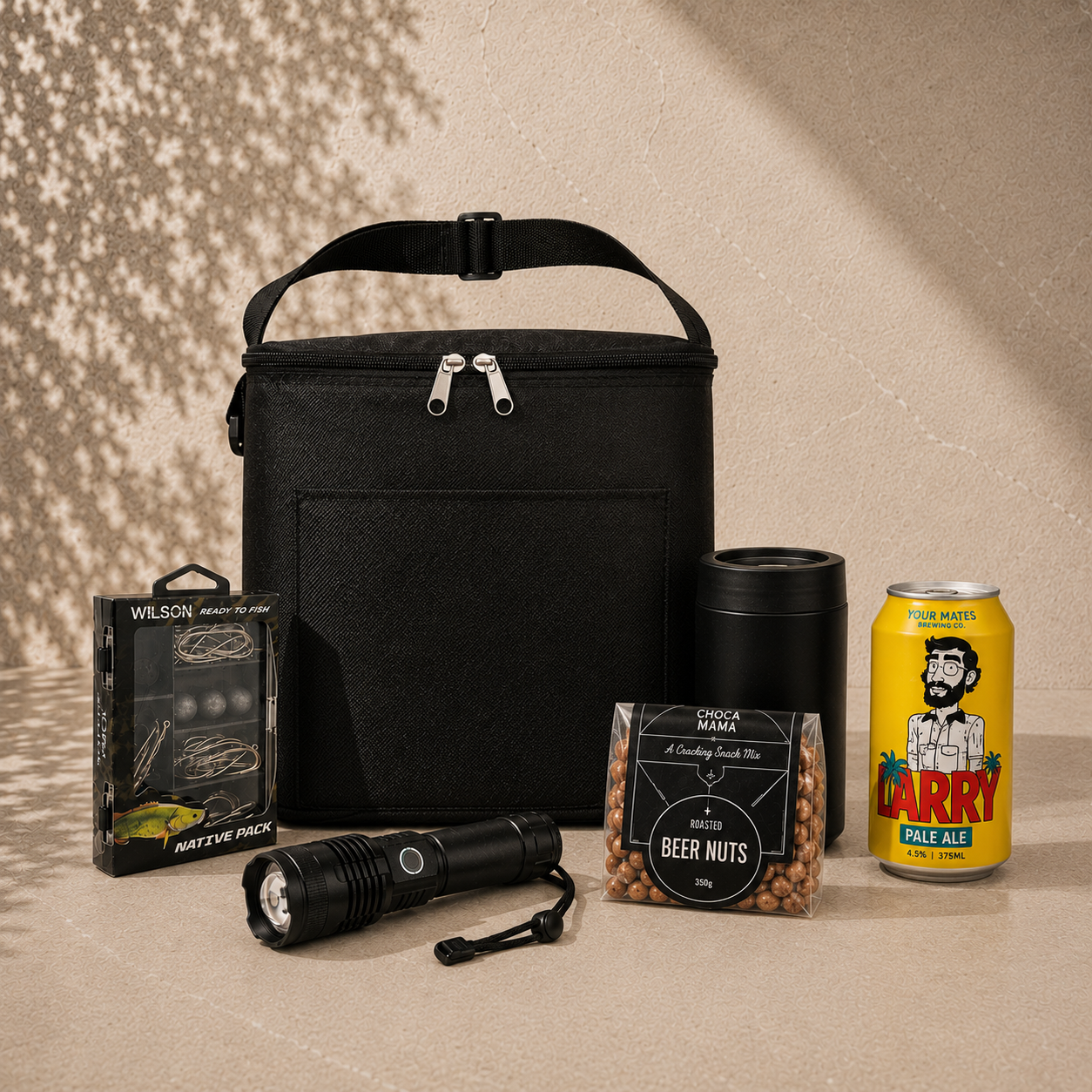 Cast Off fishing gift hamper with black insulated cooler bag, Wilson tackle kit, rechargeable torch, stainless drink cooler, beer nuts and craft beer can
