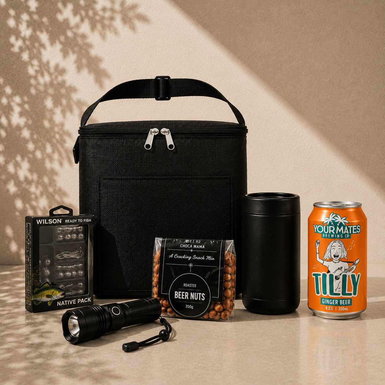 Cast Off fishing gift hamper with Tilly Ginger Beer can, black insulated cooler bag, Wilson tackle kit, rechargeable torch, drink cooler and beer nuts