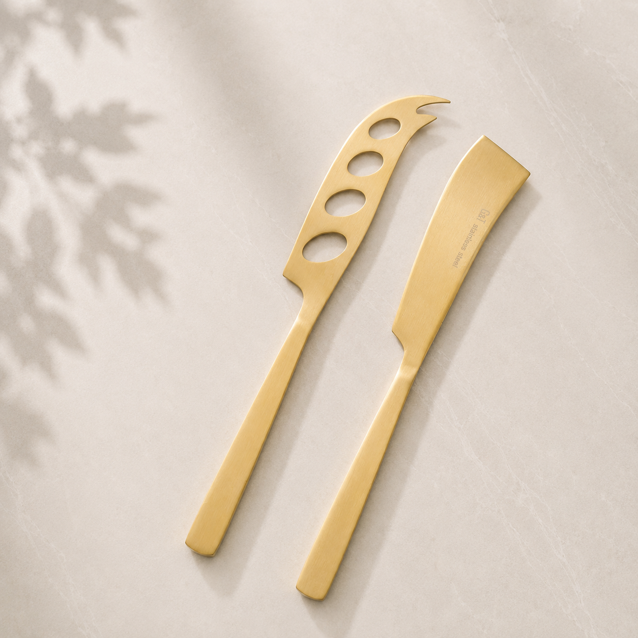 The Line Edit gold cheese knife and spreader set — included in A Little Calm at Home relaxation gift hamper by The Gifting Pantry