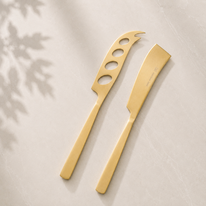 The Line Edit gold cheese knife and spreader set — included in A Little Calm at Home relaxation gift hamper by The Gifting Pantry