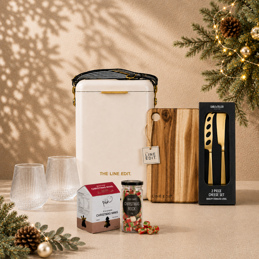 The Christmas Haul in cream — Pavilion cooler with an acacia serving board, gold cheese knife set, Velora tumblers, Christmas mint rocks and gingerbread minis, styled with pine and baubles