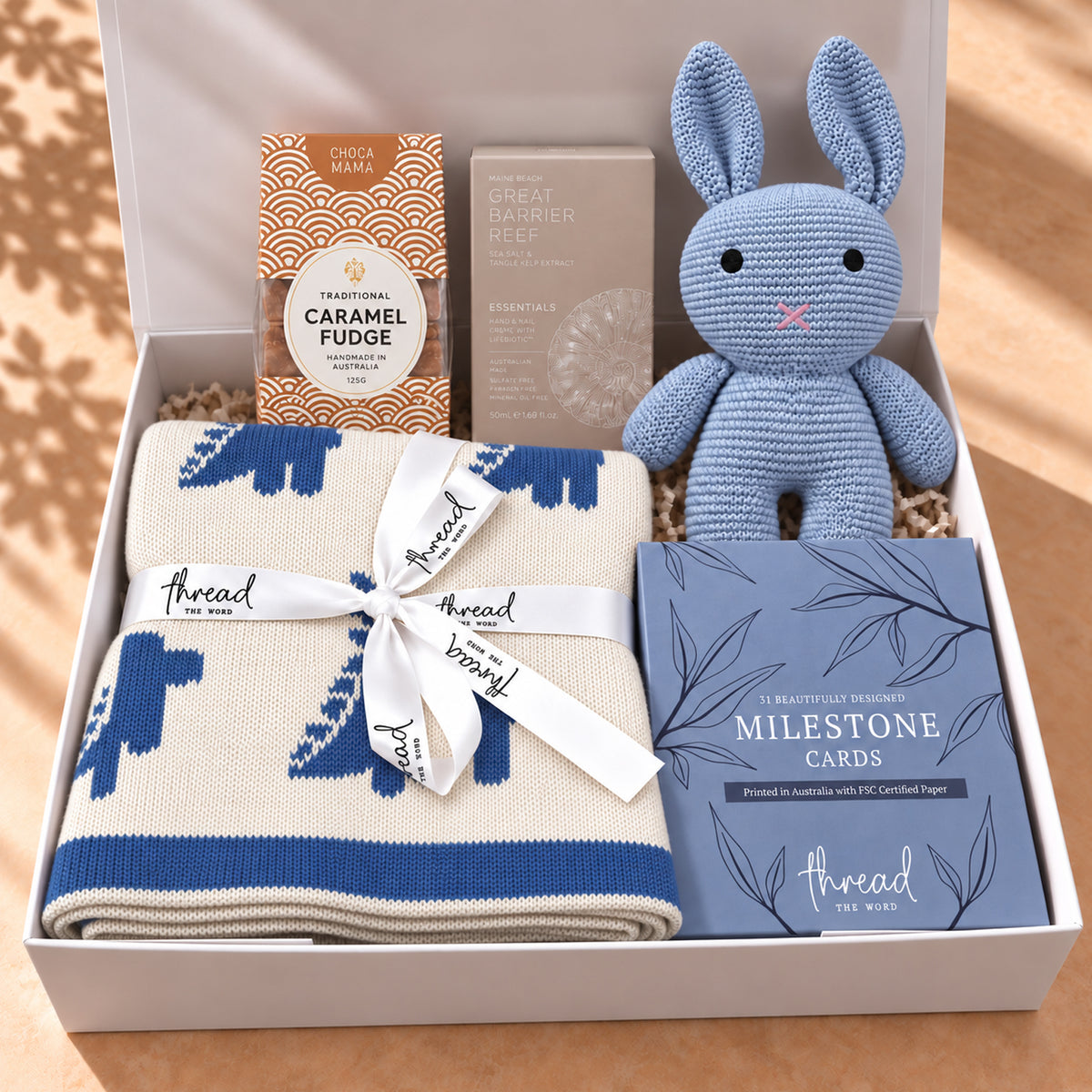 Hello Little One, and You gift hamper in Seamist, dinosaur print blanket, bunny and milestone cards packed in a white gift box