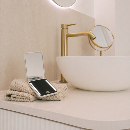 Their Little Escape pamper gift - studio-light LED compact mirror on a towel on a bathroom counter