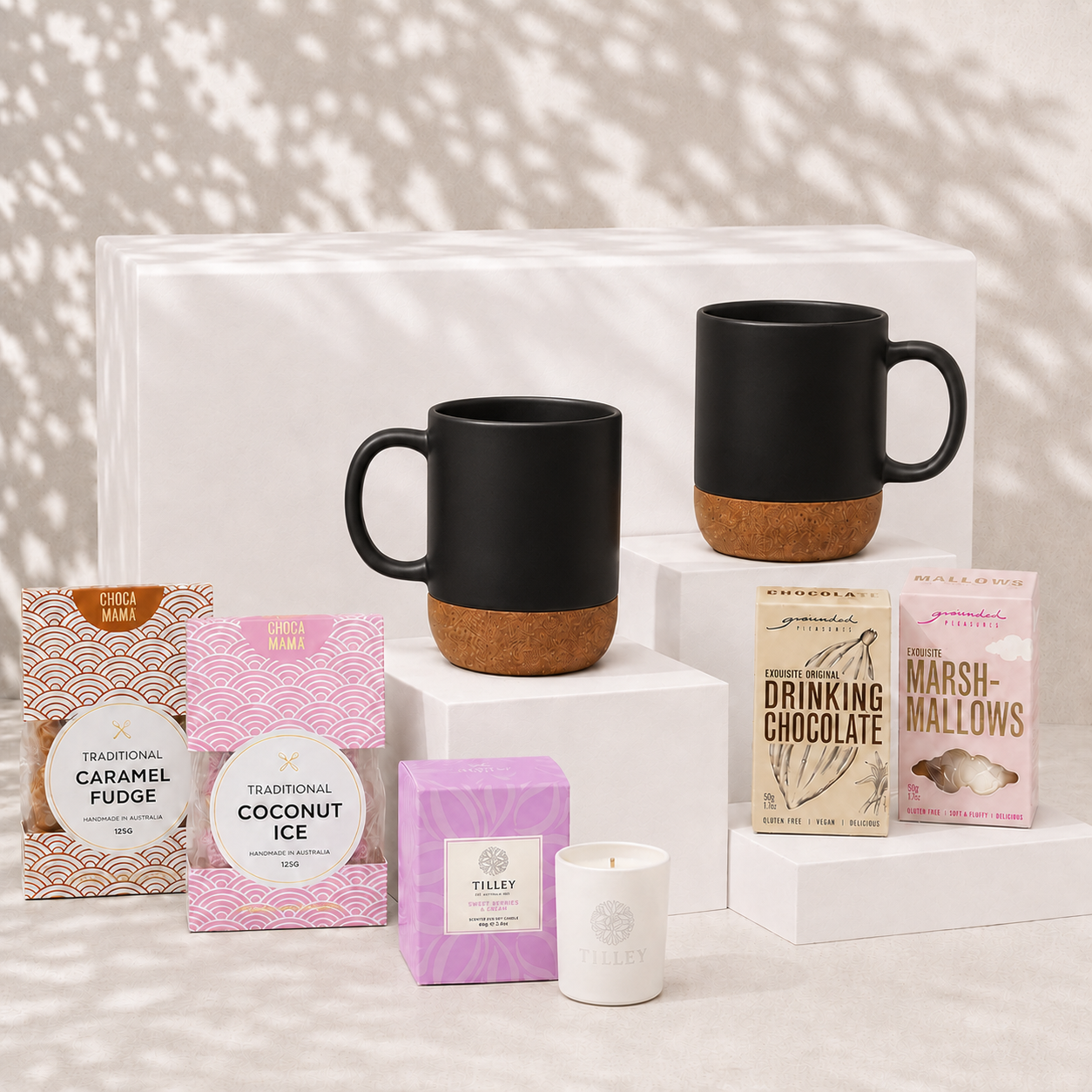 Made for Two couples gift hamper with two matte black ceramic cork-base mugs, soy candle, drinking chocolate, marshmallows, caramel fudge and coconut ice