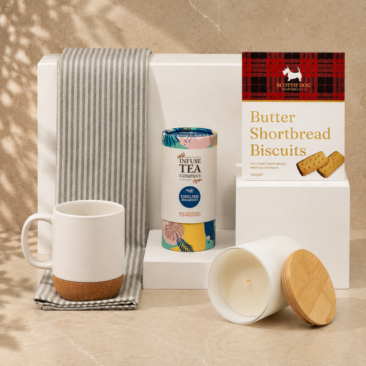 Make Yourself at Home white gift box - flat lay showing ceramic mug, Infuse English Breakfast tea, Scottie Dog shortbread biscuits, vanilla soy candle and striped tea towel