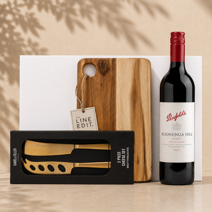 Pour, Pair & Pause wine gift set with red wine, acacia serving board, and gold cheese knife set in white gift box