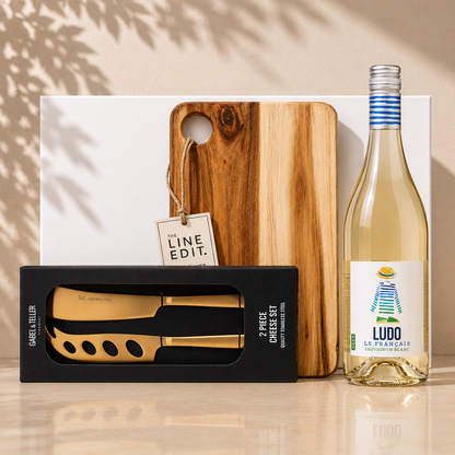 Pour, Pair & Pause wine gift set with white wine, acacia serving board, and gold cheese knife set in white gift box