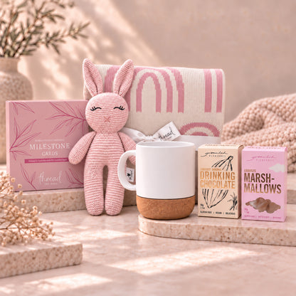 Pink new parent gift set, rainbow print blanket, pink bunny, ceramic mug, Grounded Pleasures drinking chocolate and marshmallows