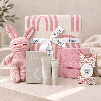 Pink baby and new parent gift set, rainbow print blanket, knitted bunny, Maine Beach skincare and caramel fudge