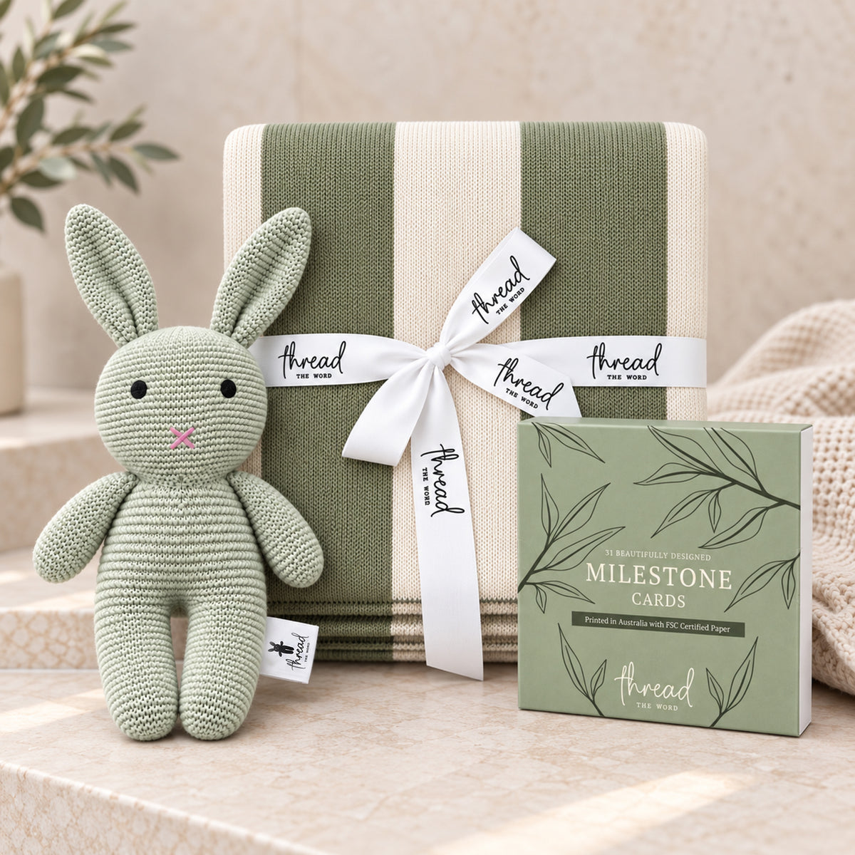 Sage baby gift set, heritage stripe cotton blanket, sage knitted bunny and Thread the Word milestone cards