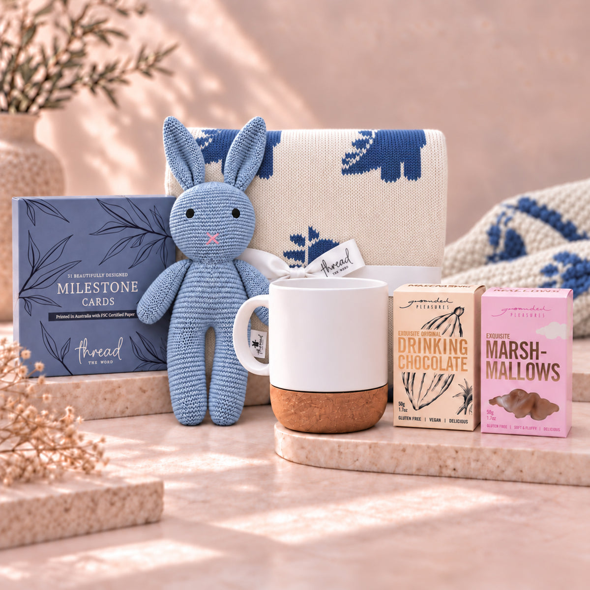 Seamist new parent gift set, dinosaur print blanket, blue bunny, ceramic mug, Grounded Pleasures drinking chocolate and marshmallows