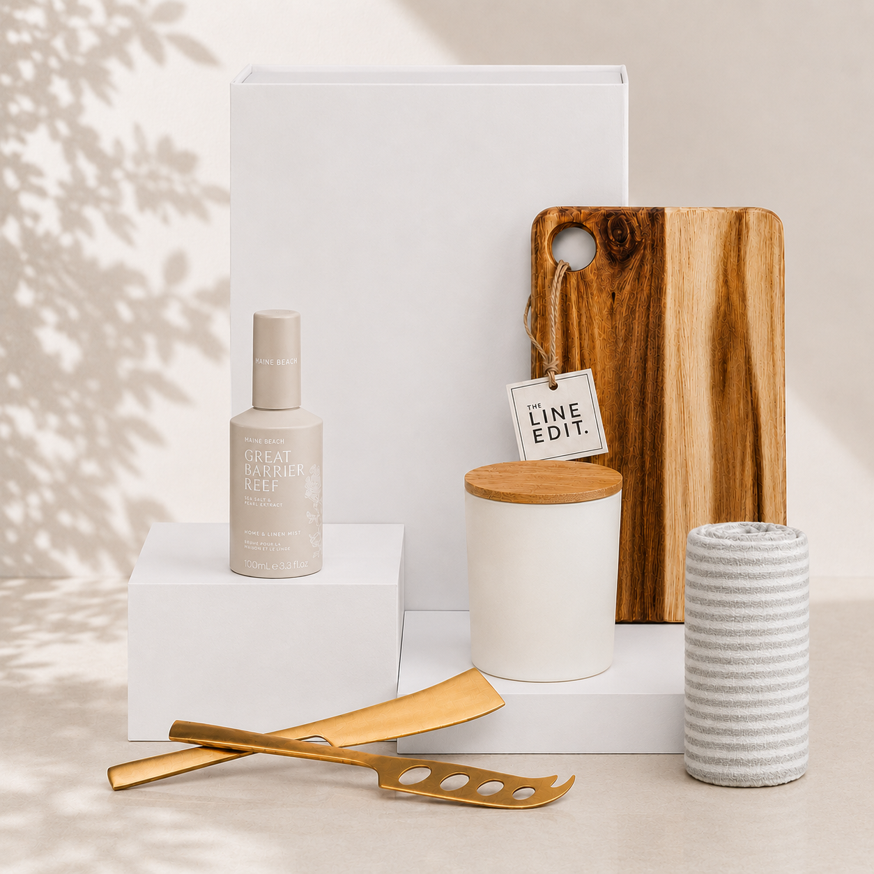 Settle In relaxation gift box by The Gifting Pantry with acacia serving board, gold cheese knife set, linen mist, vanilla candle and cotton tea towel
