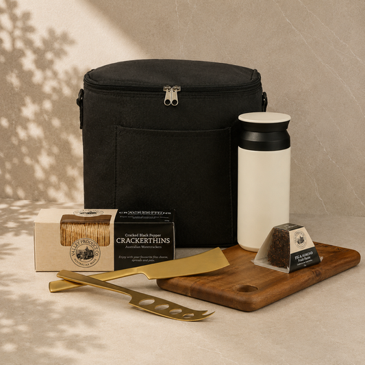 Slow Afternoons Ahead relaxation gift hamper – black cooler bag, insulated cup, serving board, gold cheese knives, crackers and fruit paste by The Gifting Pantry