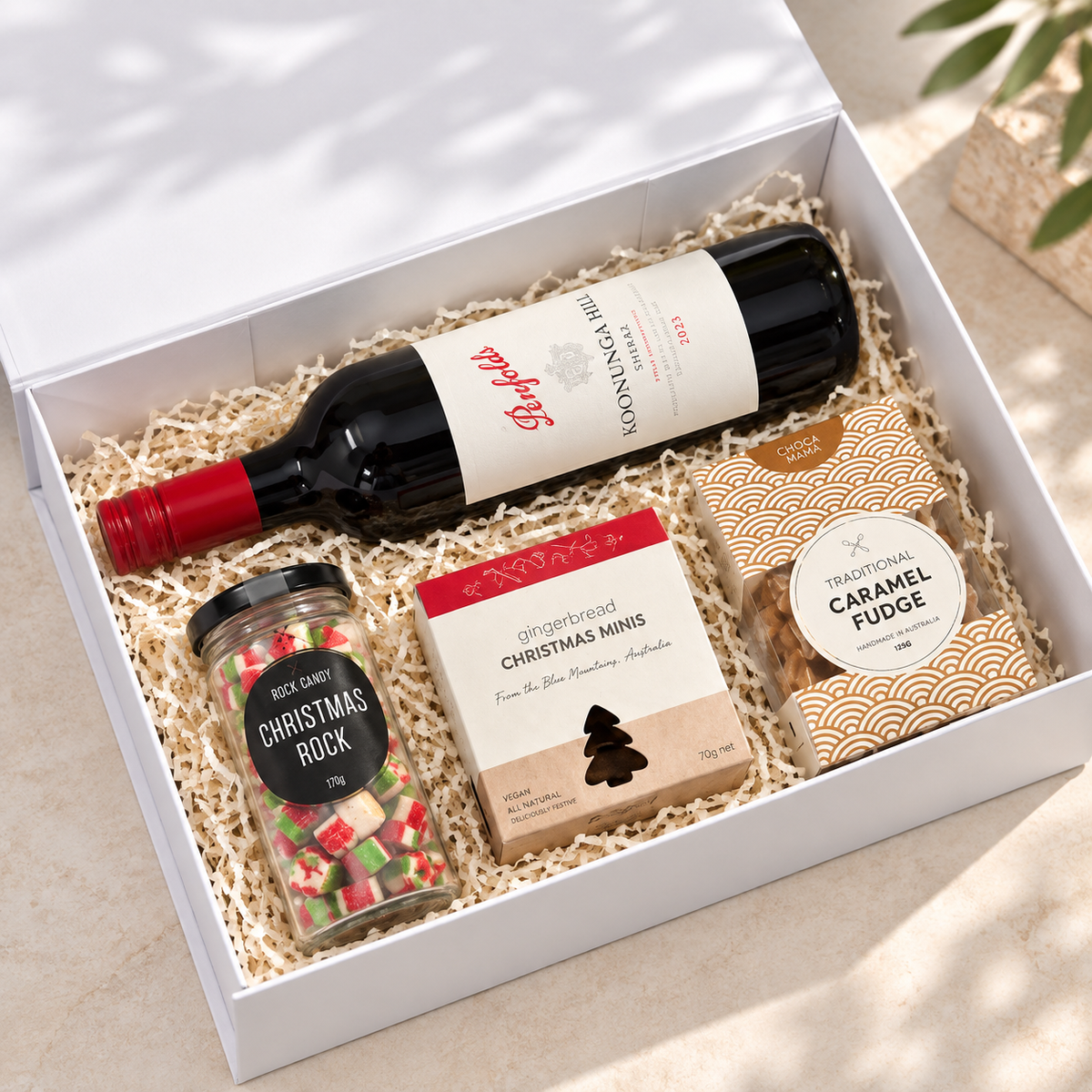 Something for the Season Christmas hamper packed in a white gift box with red wine, Christmas Rock, gingerbread and caramel fudge