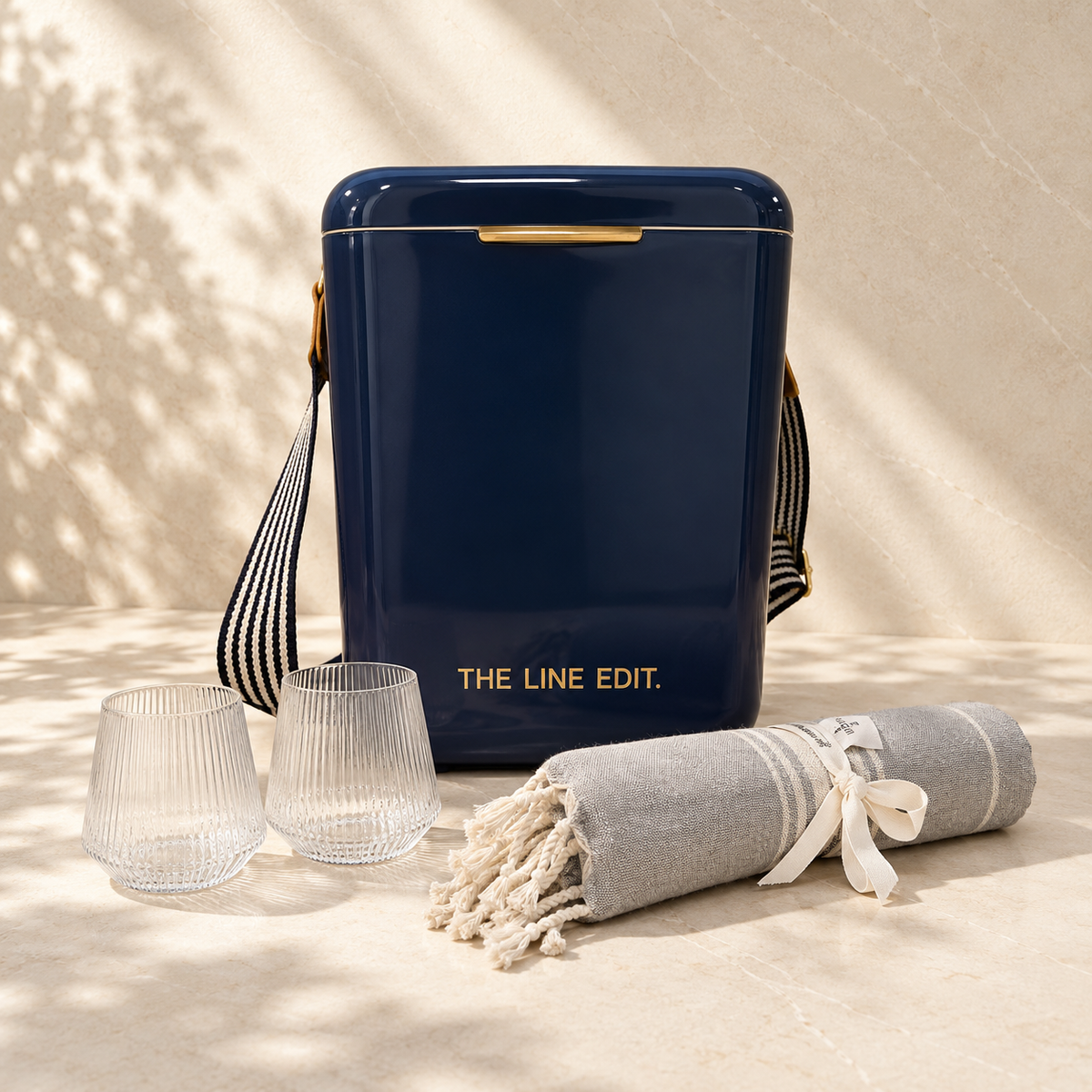 The Summer Duo summer gift hamper in navy: Pavilion cooler, two fluted tumblers and a grey Turkish towel tied with ribbon